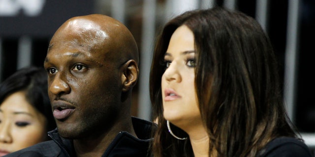 Los Angeles Lakers' Lamar Odom (L) and his wife television personality Khloe Kardashian sit courtside as they attend the 2011 BBVA All-Star Celebrity basketball game as a part of the NBA All-Star basketball weekend in Los Angeles, February 18, 2011. REUTERS/Danny Moloshok (UNITED STATES - Tags: SPORT BASKETBALL ENTERTAINMENT) - RTR2ISS6