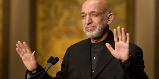 Jan. 11, 2013: Afghanistan President Hamid Karzai gestures for applause to stop before he began his speech at Georgetown University in Washington.