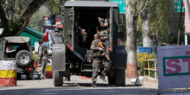 Indian army soldiers arrive at the army base which was attacked by suspected rebels in the town of Uri, west of Srinagar, Indian controlled Kashmir, Sunday.