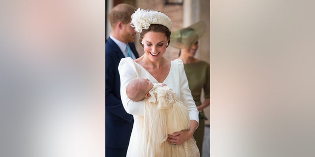 Prince Louis held by his mother Kate Middleton at his royal christening.