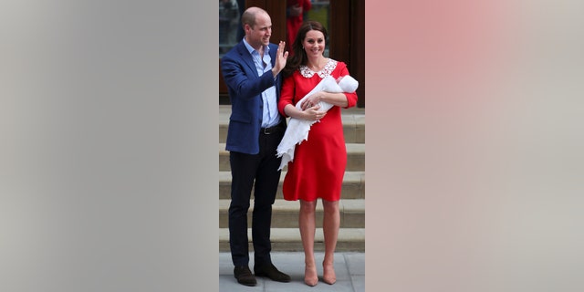 Kate and William pose outside the hospital after the birth of their third child.