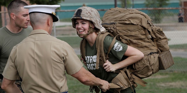 Model and actress Kate Upton tries on a Marine ruck to raise awareness for Marine Week, Tuesday, Aug. 22, 2017, in Detroit. Upton, fiancé of Detroit Tigers pitcher and Wins for Warriors founder Justin Verlander, and other Tigers Wives participated in a scaled-down workout led by Gunnery Sergeant Sara Pacheco to help support and promote the 2017 Wins for Warriors Patriot Ruck, taking place Saturday, Sept. 9 in Detroit. (AP Photo/Carlos Osorio)