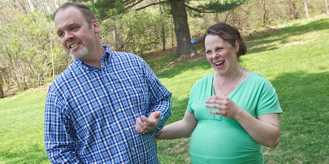 A Michigan couple with 13 sons is expecting another child and they won't know the sex until the baby is born.