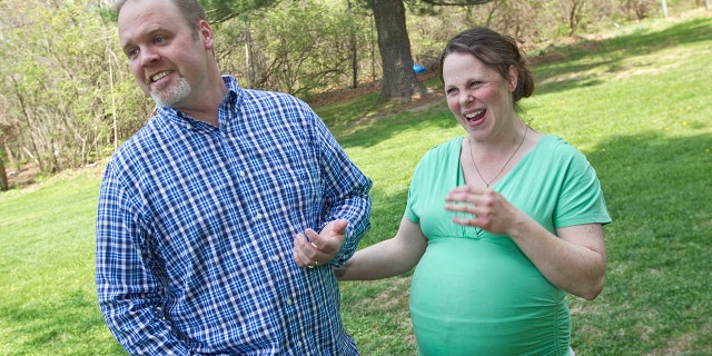 A Michigan couple with 13 sons is expecting another child and they won't know the sex until the baby is born.