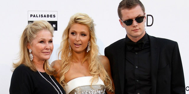May 20, 2010. Paris Hilton (C), her mother Kathy (L) and her brother Barron Nicholas Hilton arrive for the amfAR';s Cinema Against AIDS 2010 event in Antibes during the 63rd Cannes Film Festival.
