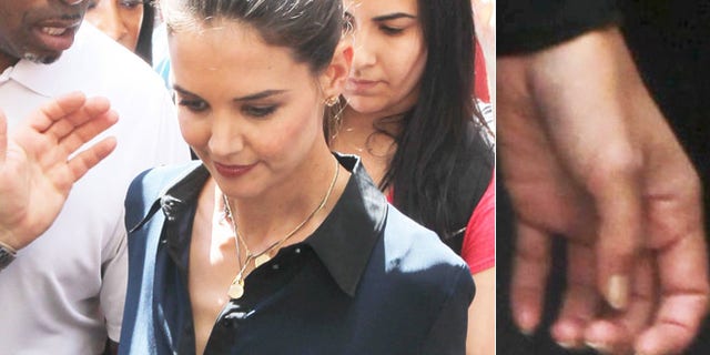 Katie Holmes is mobbed as she leaves her home to tape an episode of 'Project Runway,' sans wedding band, on July 2, 2012.