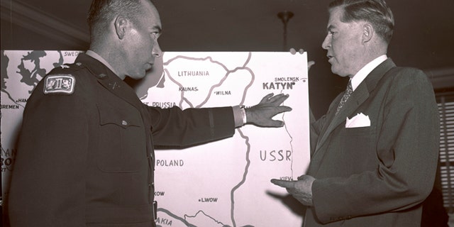 In this Oct. 11, 1951 file photo, Lt. Col. Donald B. Stewart, left, locates the site of a mass grave near near Smolensk, Russia, to Rep. Ray Madden, D-Ind., during a special House Committee hearing in Washington. Stewart and Lt. Col. John H. Van Vliet Jr., were among a group of British and American prisoners forced by the Germans to see a horrifying site, a mass grave where murdered Polish officers were buried, near Smolensk.