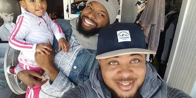 Kayden Coleman, 29 (front), with his husband, Elijah, 27, and their daughter, Azaelia.