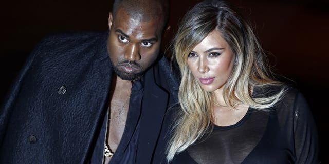 U.S. musician Kanye West and companion Kim Kardashian arrive at the Givenchy Spring/Summer 2014 women's ready-to-wear fashion show during Paris Fashion Week September 29, 2013