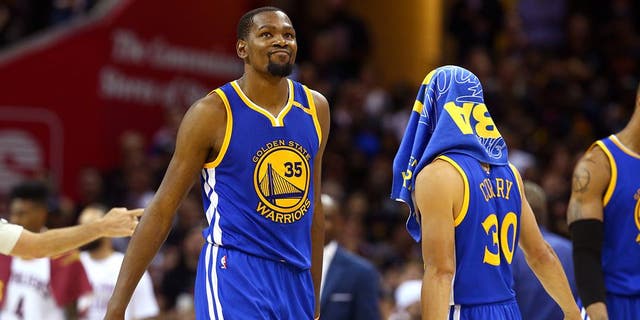CLEVELAND, OH - JUNE 07: Stephen Curry #30 and Kevin Durant #35 of the Golden State Warriors react late in the game against the Cleveland Cavaliers in Game 3 of the 2017 NBA Finals at Quicken Loans Arena on June 7, 2017 in Cleveland, Ohio. NOTE TO USER: User expressly acknowledges and agrees that, by downloading and or using this photograph, User is consenting to the terms and conditions of the Getty Images License Agreement. (Photo by Ronald Martinez/Getty Images)