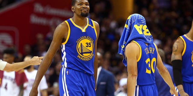 CLEVELAND, OH - JUNE 07: Stephen Curry #30 and Kevin Durant #35 of the Golden State Warriors react late in the game against the Cleveland Cavaliers in Game 3 of the 2017 NBA Finals at Quicken Loans Arena on June 7, 2017 in Cleveland, Ohio. NOTE TO USER: User expressly acknowledges and agrees that, by downloading and or using this photograph, User is consenting to the terms and conditions of the Getty Images License Agreement. (Photo by Ronald Martinez/Getty Images)