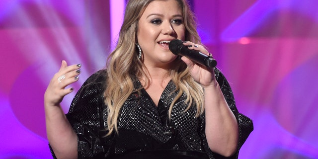 Kelly Clarkson accepts the powerhouse award at the Billboard Women in Music event at the Ray Dolby Ballroom on Thursday, Nov. 30, 2017, in Los Angeles.