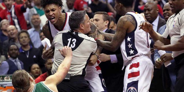 WASHINGTON D.C. - MAY 4: Tempers reach a boiling point as Washington Wizards forward Kelly Oubre Jr. (12) charges and knocks down Boston Celtics center Kelly Olynyk (41) during the second quarter. The Washington Wizards host the Boston Celtics in Game Three of the NBA Eastern Conference Semifinals at the Verizon Center in Washington, D.C. on May 4, 2017. (Photo by Barry Chin/The Boston Globe via Getty Images)