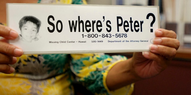File - This June 6, 2016 file photo taken in Honolulu shows a bumper sticker Hawaii officials distributed in a campaign for a Hawaii boy who disappeared 20 years ago. The child, known as "Peter Boy," became the face of missing and abused children in the late 1990s and early 2000s. The father of a Hawaii boy who went missing 20 years ago has led police to the site Sunday, April 23, 2017, where he disposed his son's remains. Peter Kema Sr. is providing information about the location of the boy's body as part of a plea deal reached earlier this month. (AP Photo/Jennifer Sinco Kelleher, File)