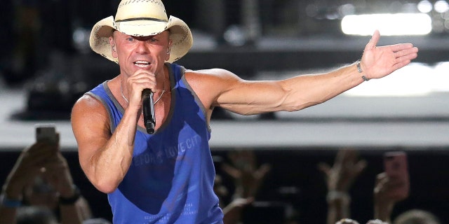 In this June 23, 2018 file photo, Kenny Chesney performs during the Trip Around the Sun Tour in Phoenix. After Hurricane Irma decimated the U.S. Virgin Islands last year, country superstar Kenny Chesney started writing songs and organizing relief efforts. Chesney is donating proceeds from the sale of his new album, “Songs for the Saints,” to a foundation he set up to support recovery on the islands.
