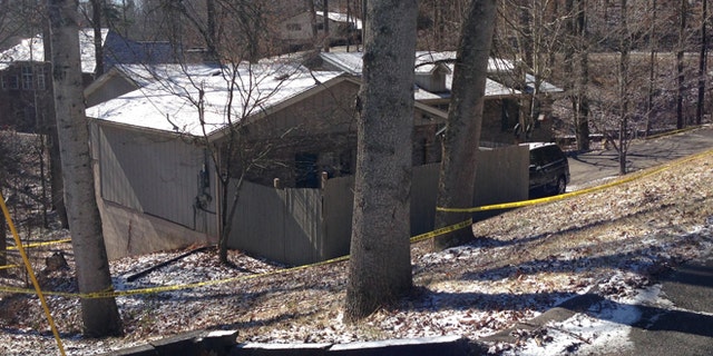 Feb. 15, 2015: Yellow tape surrounds a home in southeast Kentucky where a family was found dead. A couple and a young girl were reportedly found dead in the home on Saturday. Police are investigating to see if the case is connected to the shooting death of a young man in Baltimore on Saturday.