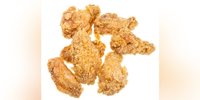 few hot fried chicken wings isolated white background