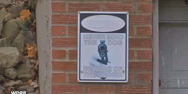 Derek Thomas has a sign out front of his home that says, "Never mind the dog. Beware the owner."