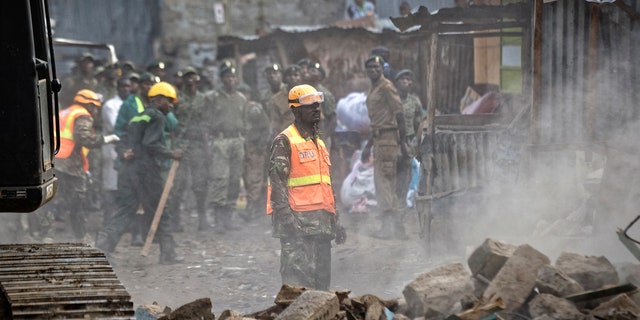 A rescuer aided by a heavy digger attends the scene of a five-storey collapsed building in the Huruma neighborhood of Nairobi, Kenya, June 3, 2018.