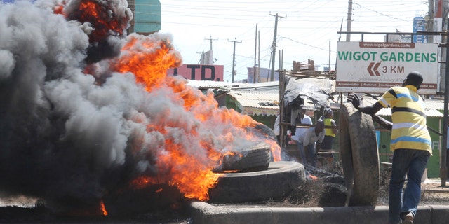 Nasa supporters burn tires, in Kisumu, Kenya, Monday Oct.2, 2017.  Kenyan police lobbed tear gas and fired shots in the air in Nairobi and Kisumu Monday to disperse protesters who are demanding a change of leadership at the country's election commission. (AP Photo)