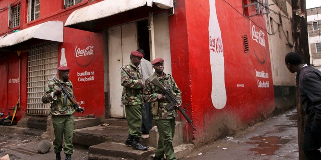 Oct. 24, 2011: Kenyan police patrol outside the pub that was the scene of a suspected grenade blast in downtown Nairobi, Kenya, which a police official said wounded over a dozen people.
