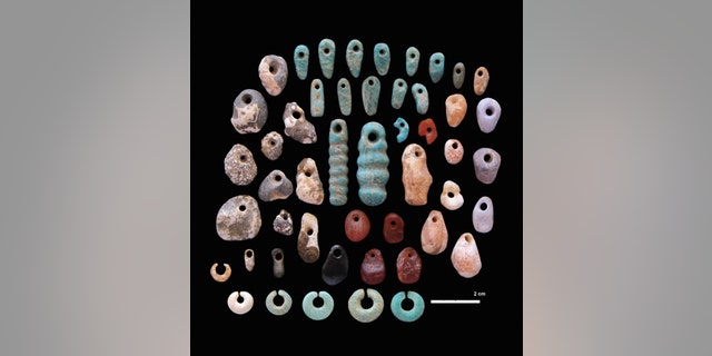 Stone pendants and earrings found in the communal cemetery (Image courtesy of Carla Klehm)