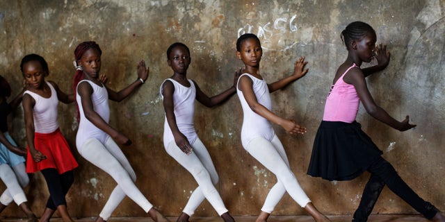 Young ballerinas practice under the instruction of Kenyan ballet dancer Joel Kioko, 16.