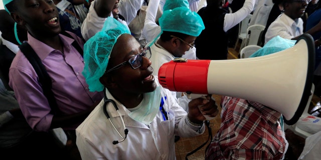 A Kenyan doctor uses a megaphone to shout a slogan to demand fulfilment of a 2013 agreement between their union and the government that would raise their pay and improve working conditions at a meeting in Nairobi, Kenya December 5, 2016.