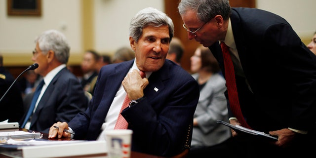 Sept. 4, 2013: Secretary of State John Kerry confers with U.S. Ambassador to Syria Robert Ford, right, as Kerry testifies at a House Foreign Affairs Committee hearing on Syria on Capitol Hill in Washington.