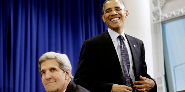 Sept. 24, 2013: President Obama walks past Secretary of State John Kerry during a meeting at U.N. headquarters in New York.