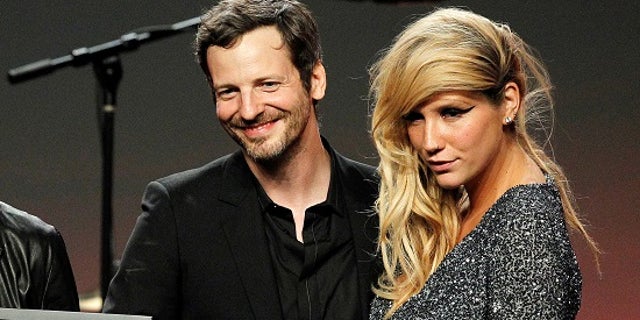 FILE PHOTO - Songwriter Lukasz Gottwald (L), better known as Dr. Luke, accept the Songwriter of the Year award from presenters Adam Lambert (not shown) and Kesha (R) at the 28th annual ASCAP (American Society of Composers, Authors and Publishers) Pop Music Awards in Hollywood, California, U.S. on April 27, 2011. REUTERS/Mario Anzuoni/File Photo - RTSYVKJ