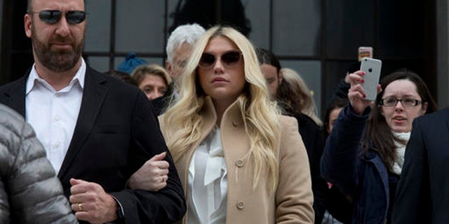 In this Feb. 19, 2016 file photo, pop star Kesha, center, leaves Supreme court in New York.