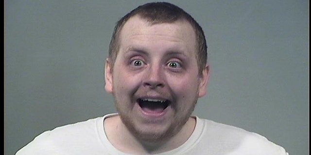 Kenneth Evans, 24, was arrested after attacking his girlfriend, at one point hitting her in the face with a pizza, police said.
