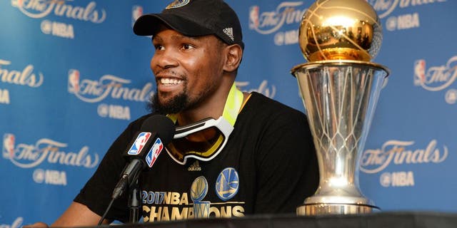 OAKLAND, CA - JUNE 12: NBA Finals MVP Kevin Durant #35 of the Golden State Warriors speaks to the media after winning the NBA Championship in Game Five of the 2017 NBA Finals against the Cleveland Cavaliers on June 12, 2017 at ORACLE Arena in Oakland, California. NOTE TO USER: User expressly acknowledges and agrees that, by downloading and/or using this photograph, user is consenting to the terms and conditions of Getty Images License Agreement. Mandatory Copyright Notice: Copyright 2017 NBAE (Photo by Andrew D. Bernstein/NBAE via Getty Images)