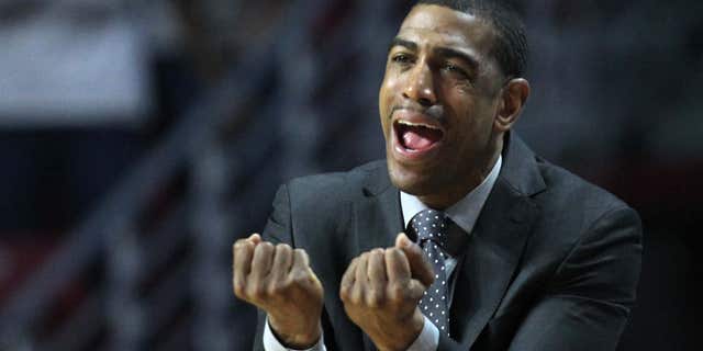 March 7, 2015: Connecticut coach Kevin Ollie shouts from the bench during a game with Temple in the second half of an NCAA college basketball game.