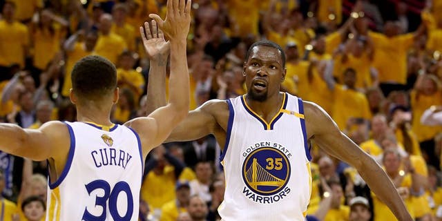 OAKLAND, CA - JUNE 04: Stephen Curry #30 and Kevin Durant #35 of the Golden State Warriors react to a play against the Cleveland Cavaliers in Game 2 of the 2017 NBA Finals at ORACLE Arena on June 4, 2017 in Oakland, California. NOTE TO USER: User expressly acknowledges and agrees that, by downloading and or using this photograph, User is consenting to the terms and conditions of the Getty Images License Agreement. (Photo by Ezra Shaw/Getty Images)