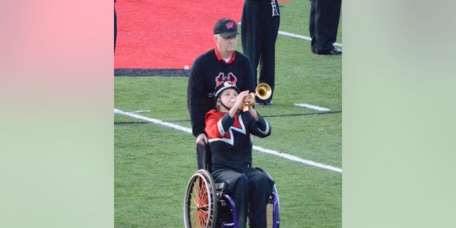 Kevin and Eva Houston perform during the marching band's halftime routine.