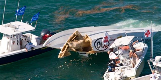 Nov. 9, 2011: In this photo, provided by the Florida Keys News Bureau, rescue personnel, right, work on extracting offshore powerboat racers Robert M. Morgan of Sunrise Beach, Mo., and Jeffrey Tillman of Kaiser, Mo., after their 46-foot catamaran was involved in an accident, during the first of three race days at the Key West World Championship in Key West, Fla.