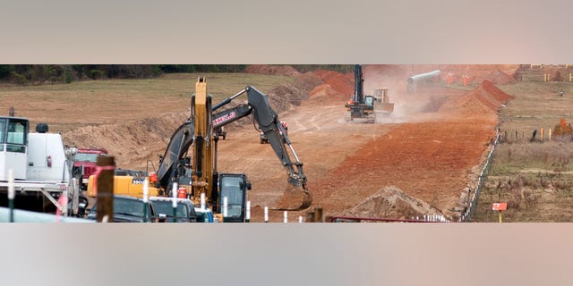 FILE - In this Dec. 3, 2012 file photo, crews work on construction of the TransCanada Keystone XL Pipeline near County Road 363 and County Road 357, east of Winona, Texas. In a move that disappointed environmental groups and cheered the oil industry, the Obama administration on Jan. 31, 2014, said it had no major environmental objections to the proposed Keystone XL oil pipeline from Canada. (AP Photo/The Tyler Morning Telegraph, Sarah A. Miller)
