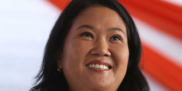 FILE - In this May 10, 2016 file photo, presidential candidate Keiko Fujimori campaigns in the San Juan de Lurigancho shantytown on the outskirts of Lima, Peru, ahead of elections in June. Fujimori is denying reports that the U.S. DEA is investigating a member of her party for money laundering. A local television network broadcast a report Sunday night suggesting the agency was investigating whether Joaquin Ramirez of Fujimori's Fuerza Popular party had laundered millions for the candidate. Ramirez and Fujimori denied the allegations and Fujimori said on Monday that she would ask the DEA about the report. (AP Photo/Martin Mejia, File)