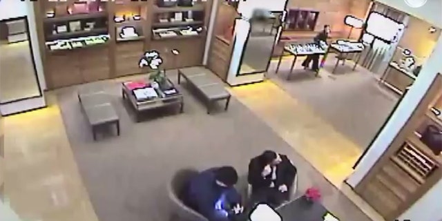 Screen grab of surveillance released by police about a student being forced to withdraw money.