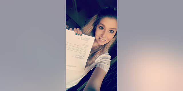 Jen Walker shows the letter that says she has been approved to donate a kidney.