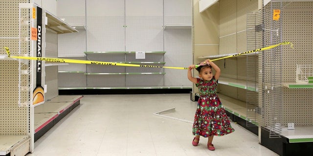 A young plays in an empty isle of a Toys R Us store in Houston on Thursday, June 28, 2018.
