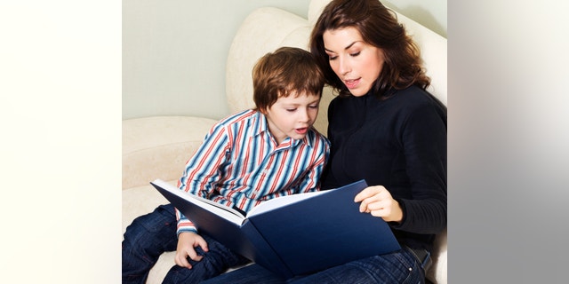 Mother reading to her child an interesting story