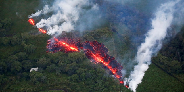 Lava erupts from a fissure east of the Leilani Estates subdivision during ongoing eruptions of the Kilauea Volcano in Hawaii, U.S., May 13, 2018. (REUTERS/Terray Sylvester)