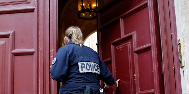 A police officer stands guard at the entrance of a luxury residence on the Rue Tronchet in central Paris, France, October 3, 2016 where masked men robbed U.S. reality TV star Kim Kardashian.