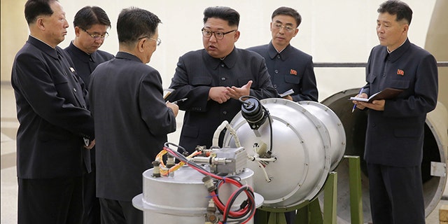Kim Jong Un provides guidance with Ri Hong Sop (3rd L) and Hong Sung Mu (L) on a nuclear weapons program in this undated photo released by North Korea's Korean Central News Agency (KCNA) in Pyongyang, September 3, 2017.