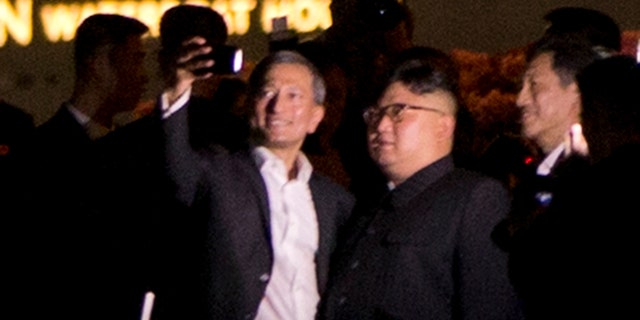 Kim Jong Un leaving St. Regis Hotel in Singapore for a mini tour of the city.