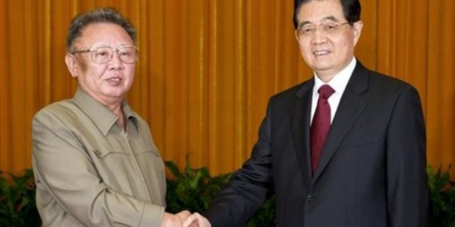 In this photo taken Wednesday, May 25, 2011 released by China's Xinhua news agency, North Korean leader Kim Jong Il, left, shakes hands with Chinese President Hu Jintao during a meeting in Beijing.