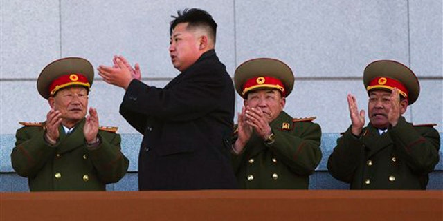 Feb. 16, 2012: North Korean leader Kim Jong Un, second from left, applauds as he leaves the stands at Kumsusan Memorial Palace in Pyongyang.